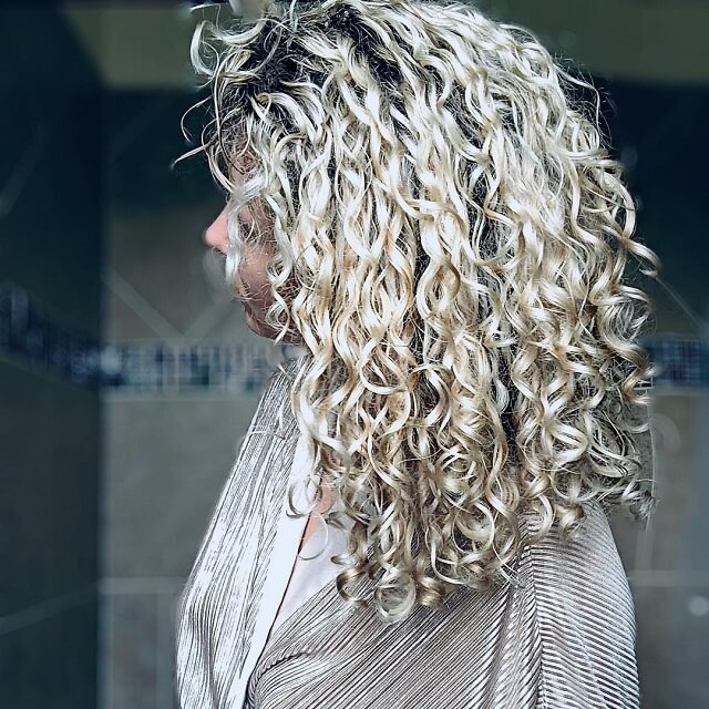 ash blonde balayage curly hair