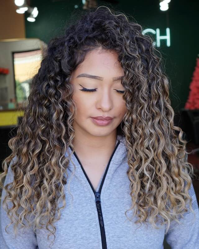 caramel balayage on dark curly hair 