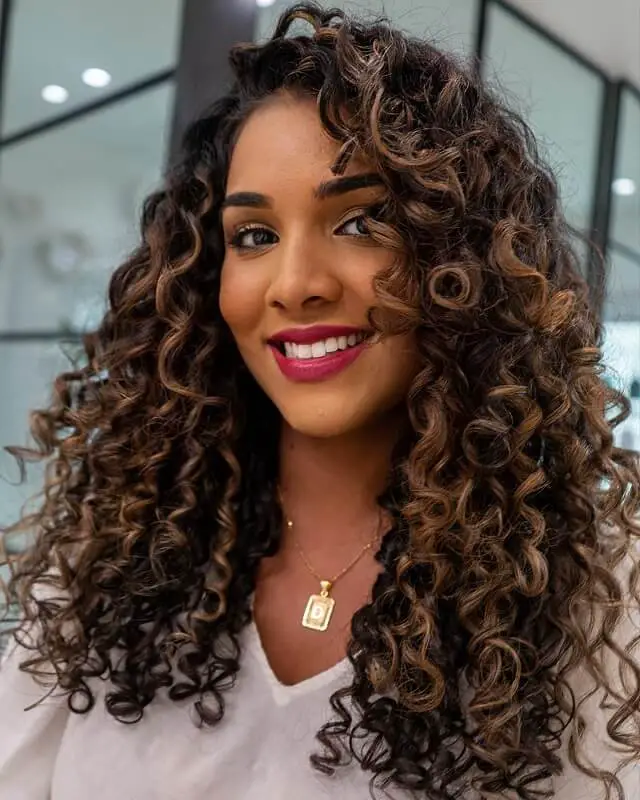 dark brown curly hair with highlights